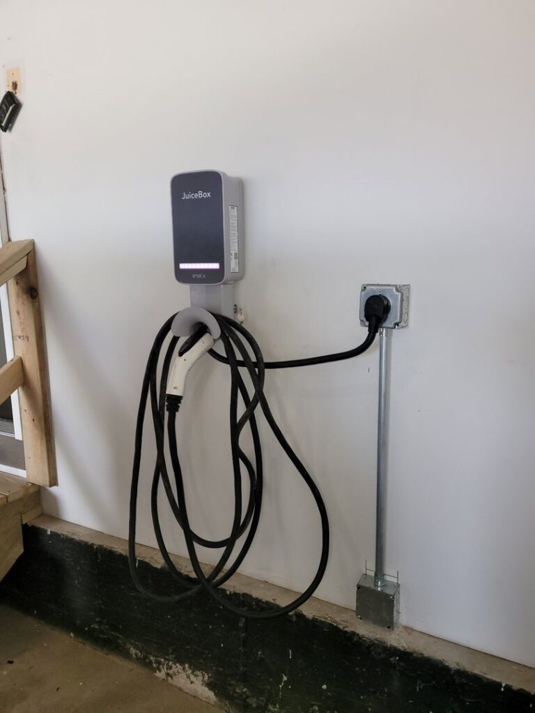 An installed EV charger with conduit, showcasing an electrical service by Illiana Electrical in Whiting, IN