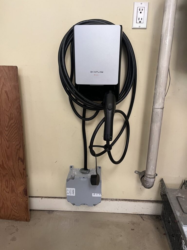 An Ecoflow EV charger professionally installed on a wall with a nearby electrical outlet by Innovate Electric in Earth City, MO.