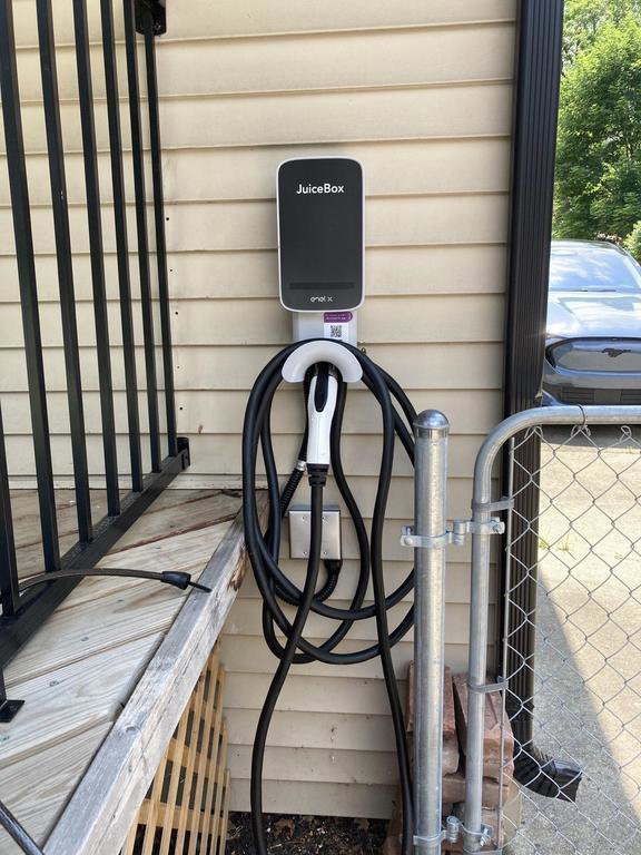 An installed JuiceBox EV charging station on a residential exterior by Detroit Voltage in Detroit, MI.