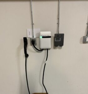 An EV charger installation with conduits and electrical outlets on a wall by Muse Electricians in Los Angeles, CA.