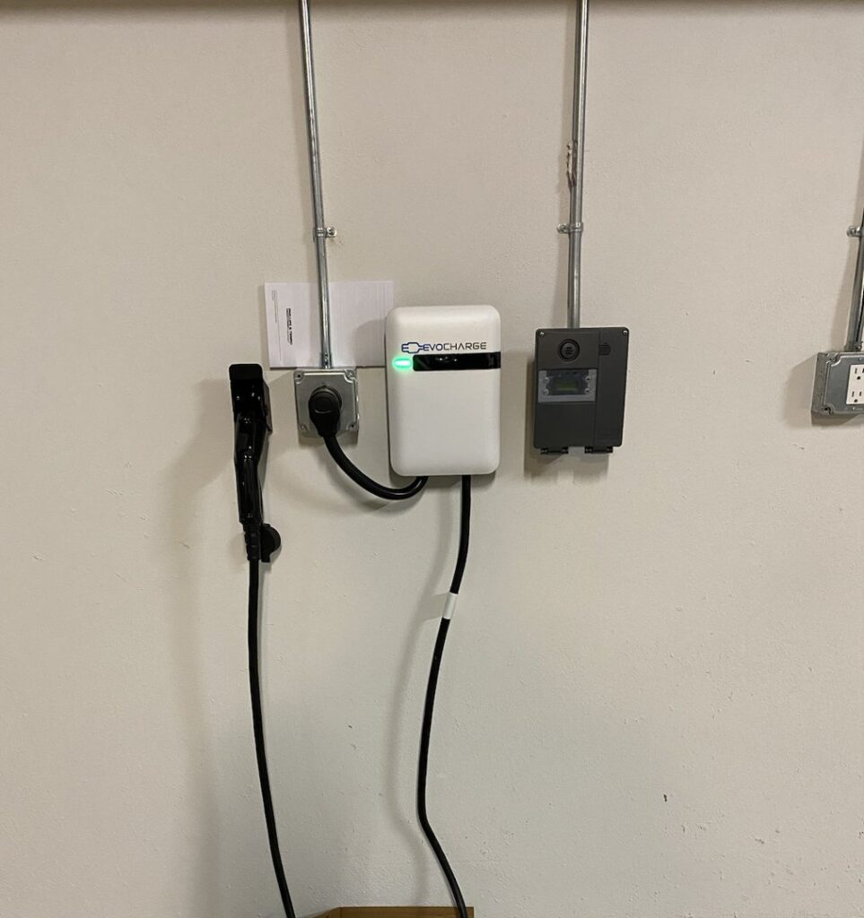 An EV charger installation with conduits and electrical outlets on a wall by Muse Electricians in Los Angeles, CA.