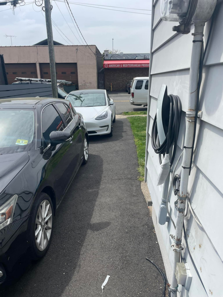 An electric vehicle charger installed on the side of a house by Ruben's Electric in Harlingen, TX