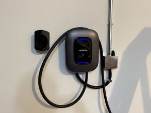 A Tesla Wall Connector EV charger professionally installed with conduit by Big Red Electric Company in San Antonio, TX.