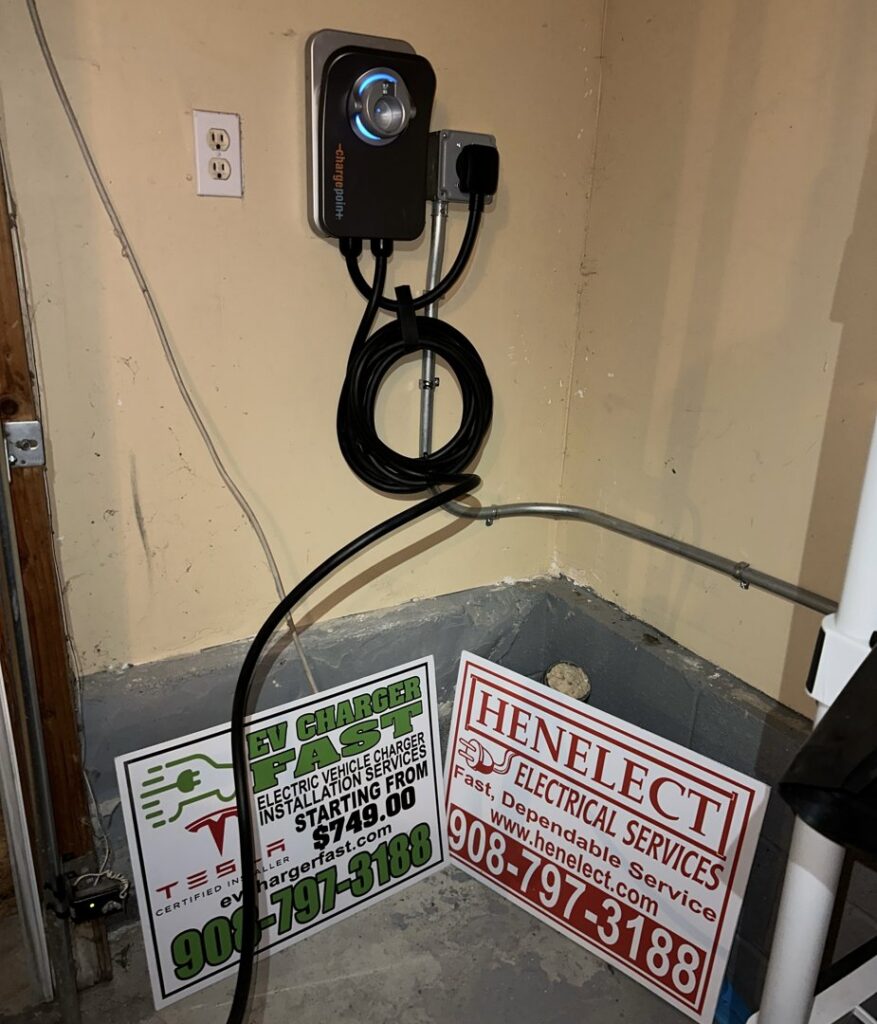 An EV charger installation with Henelect Electrical Contractors business signs in Milford, NJ.