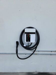 An electric vehicle charger with visible wiring and conduit, installed by Wisdom Electrical in San Francisco, CA.
