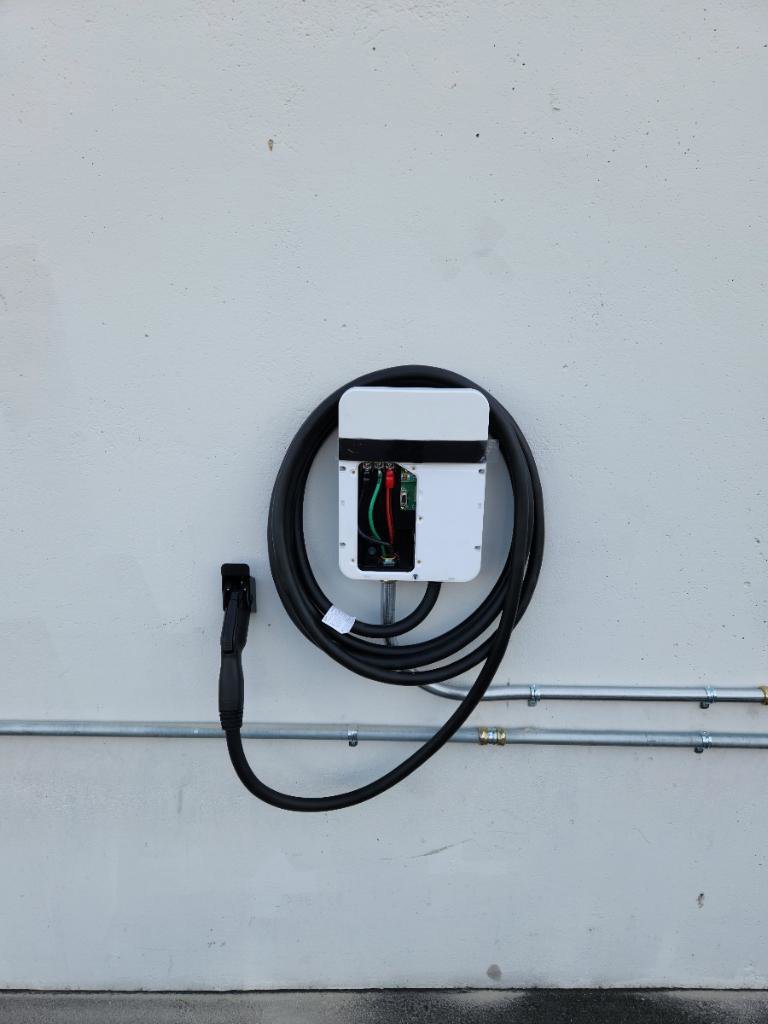An electric vehicle charger with visible wiring and conduit, installed by Wisdom Electrical in San Francisco, CA.