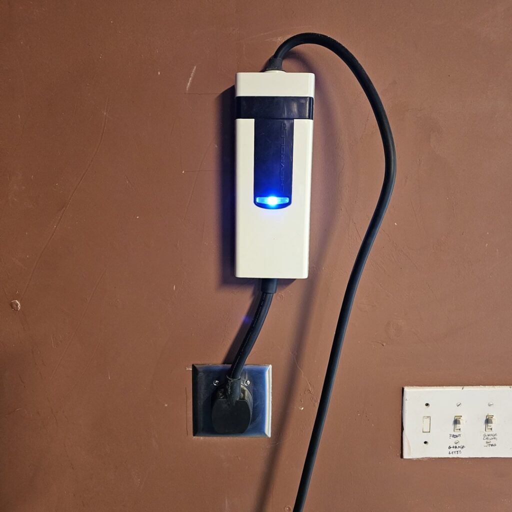 An electric vehicle (EV) charging station installed on a wall, ready for use by Bee Thumb Electric in North Highlands, CA.