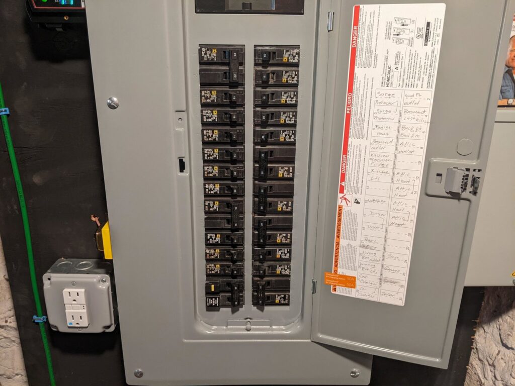 An electric vehicle (EV) charging station installed on an exterior wall by Border Electrical Contractor LLC in Nashua, NH.