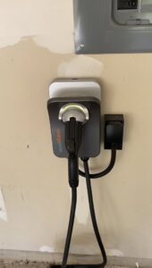 An EV charging station (ChargePoint) installed in a garage by Outlaw Home Services, LLC in San Antonio, Tx.