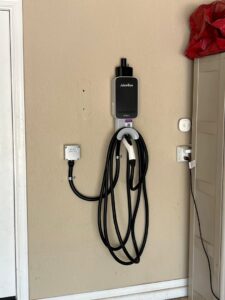 An EV charging station (JuiceBox) professionally installed on a wall by Industrial Edge Electrical in Gilbert, AZ.