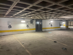 Multiple EV charging stations and new lighting installed in a parking garage by Eriginal Electric LLC in Waterbury, CT.
