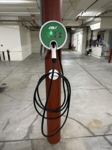 An EV charging station installed on a pillar in a parking garage by Thee electrician in San Francisco, CA