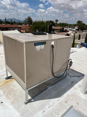 A large evaporative cooler unit installed on a commercial rooftop, maintained by Anchor Air in El Paso, TX