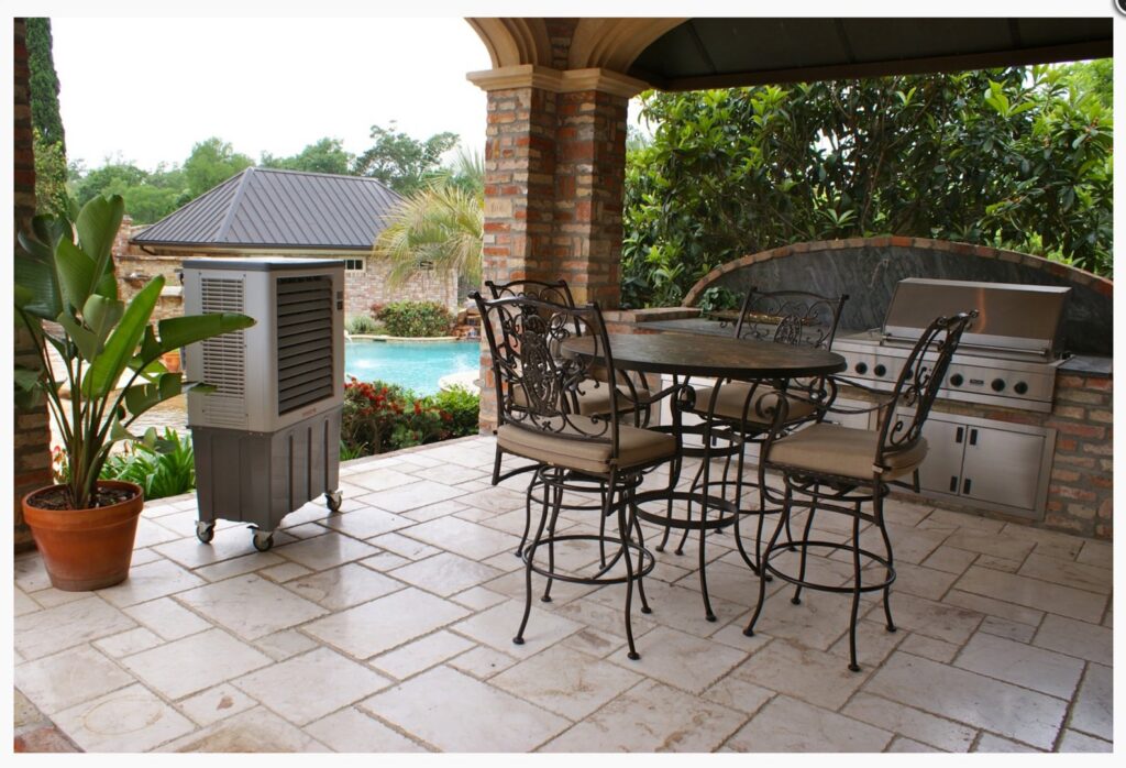 An evaporative cooler cooling an outdoor kitchen and pool area by Cajun Kooling in Broussard, LA