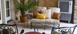 An evaporative cooler providing comfort for an outdoor seating area by Cajun Kooling in Broussard, LA