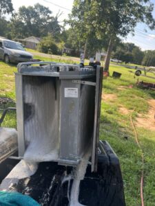 An evaporator coil being cleaned with foaming solution during HVAC maintenance by Circle L Heating and Cooling LLC in Atmore, AL.