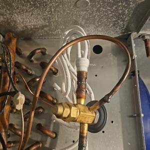 Evaporator coil with copper refrigerant lines and TXV valve, serviced by HVAC and Appliances repair LLC in Arlington, VA.