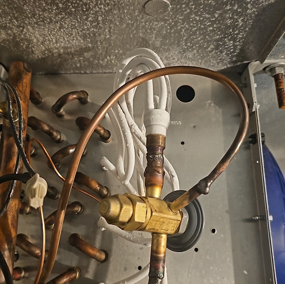Evaporator coil with copper refrigerant lines and TXV valve, serviced by HVAC and Appliances repair LLC in Arlington, VA.