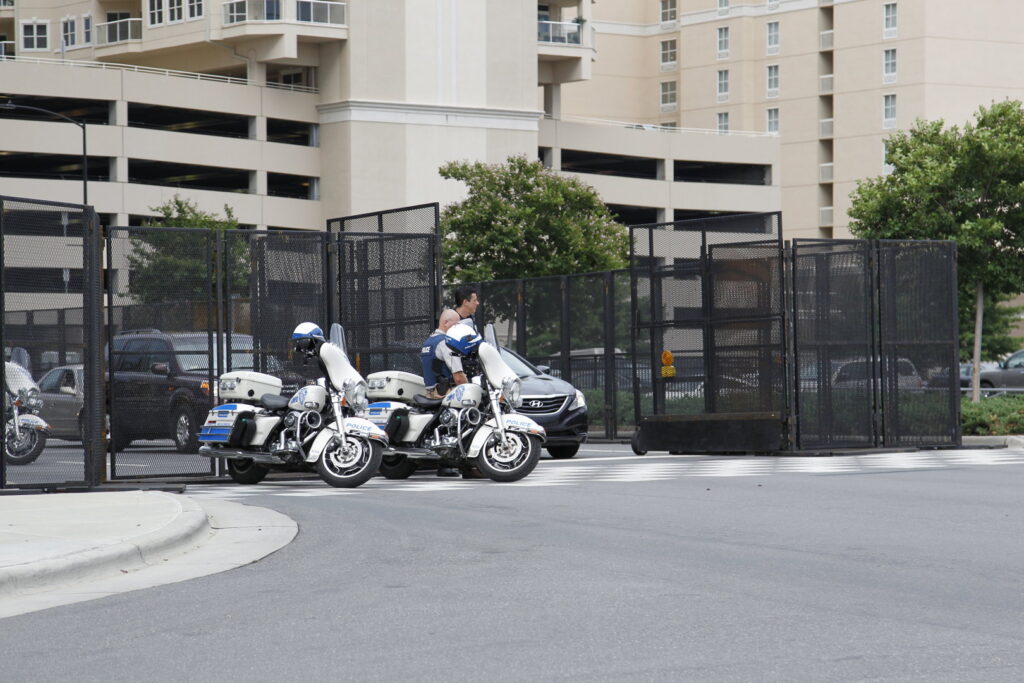 Event security fencing with police motorcycles providing perimeter control by Checkmate Global in Frederick, MD.