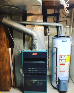 An existing Bryant furnace and water heater system in a utility room by Excellence Heating & Air in Rohnert Park, CA