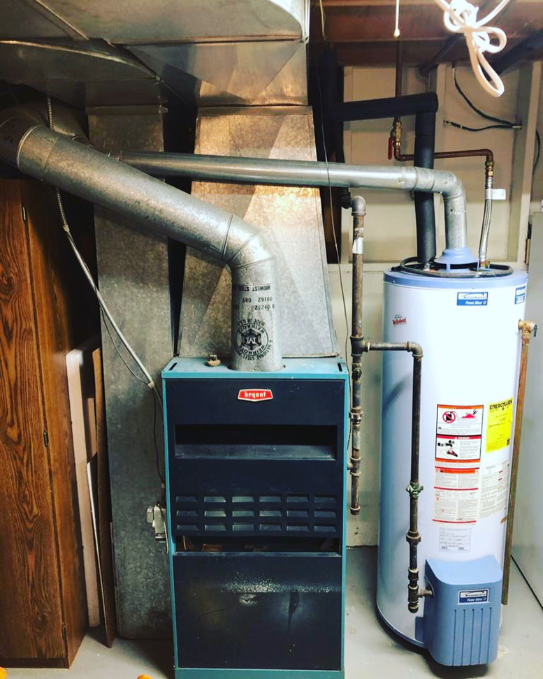 An existing Bryant furnace and water heater system in a utility room by Excellence Heating & Air in Rohnert Park, CA