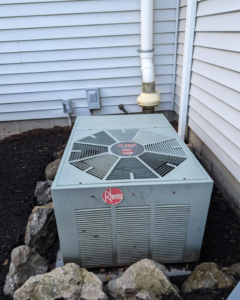 An existing Rheem outdoor AC unit, ready for service or replacement by Frank N Frank Mechanical Contractors in Rochester, NY.