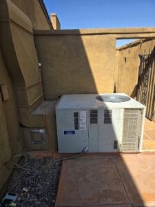 An existing outdoor AC unit and associated ductwork next to a building, representing HVAC service capabilities by State 48 Home Comfort LLC in Peoria, AZ.