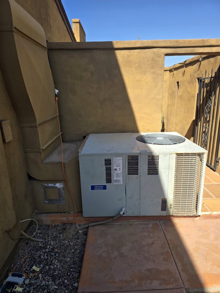 An existing outdoor AC unit and associated ductwork next to a building, representing HVAC service capabilities by State 48 Home Comfort LLC in Peoria, AZ.