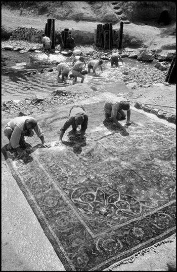 Experts hand-washing a large oriental rug outdoors as part of the cleaning process at Rub A Dub Rug in Las Vegas, NV.