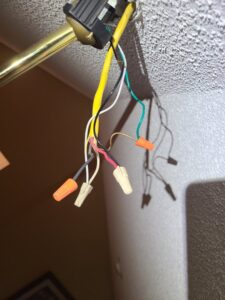 Exposed ceiling fixture wiring with wire nuts, indicating electrical work in progress by 8Thirty Electric, Inc. in Johns Creek, GA.