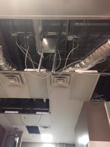 Exposed commercial ceiling showing electrical wiring, conduits, and ductwork by Allied Electric Company of Minnesota in Minneapolis, MN