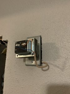 An exposed doorbell transformer installation on a wall by Interstate Electrical Contractors in Dalton Gardens, ID.
