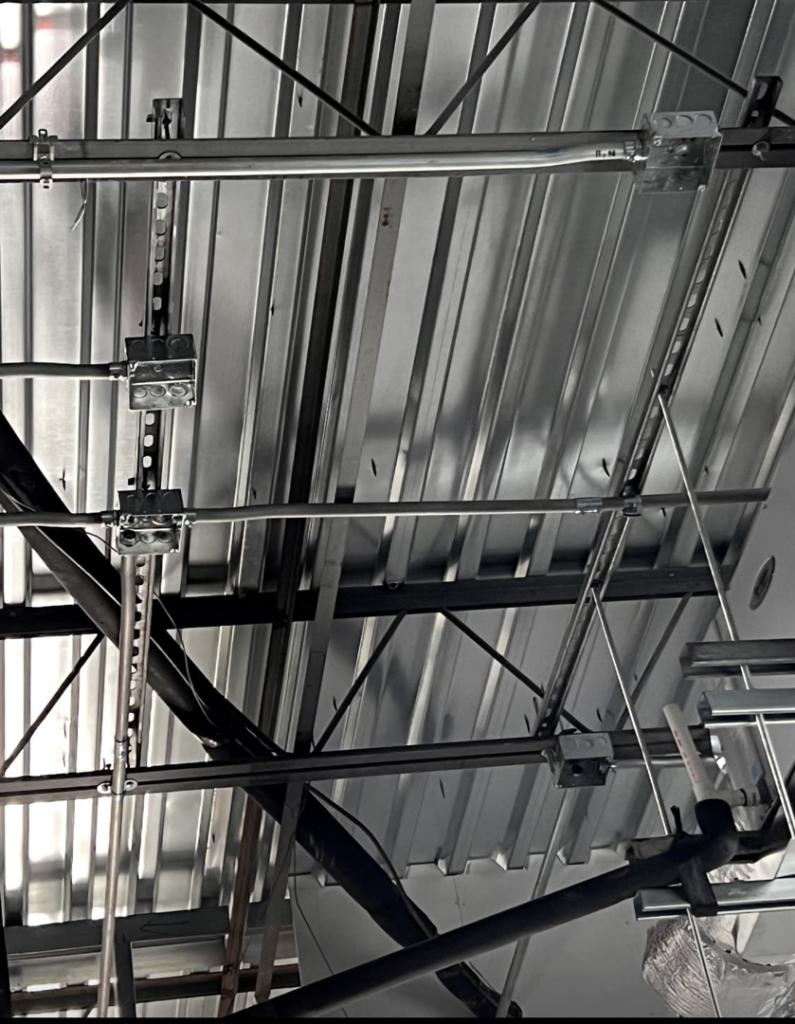 Exposed electrical conduits and wiring installed on a commercial ceiling structure by My A Plus Electric SA in San Antonio, TX