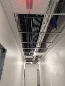 Exposed electrical conduits and wiring visible in an unfinished ceiling during an installation project by Zuz Electric in Houston, TX.