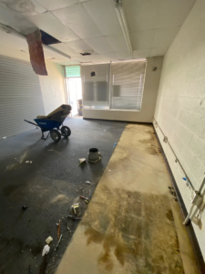 Exposed electrical conduits and junction boxes on a wall during a commercial renovation by Redbud Current Co., LLC in Tulsa, OK.