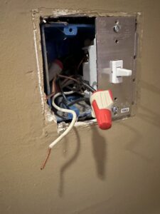 Exposed electrical wires and a light switch in an open wall box, showing electrical repair work by Murray Electric & Plumbing in Broken Arrow, OK.