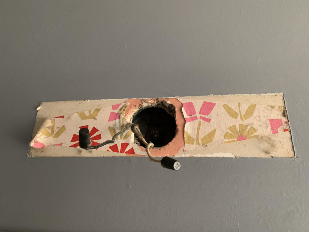 Exposed electrical wires from a removed ceiling fixture, showing a common electrical repair scenario by Dmac Electric in Detroit, MI