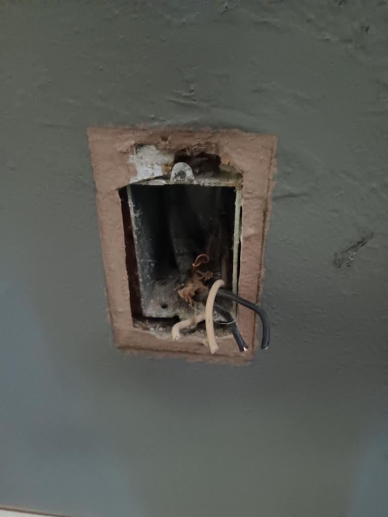 Exposed electrical wires in an open outlet box during an installation or repair by Aegis Electric in Albuquerque, NM.