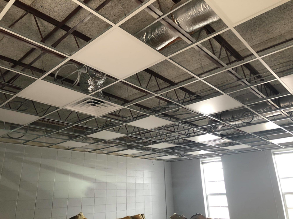 Exposed electrical wiring and conduit above a ceiling grid, showcasing work by Eastmont Electric Company, Inc. in Montgomery, AL.