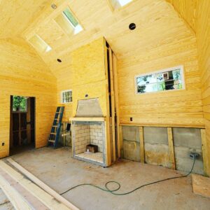 Exposed electrical wiring and an outlet box in a room under construction with wooden walls, installed by Corey N Craig Electric LLC in Charlotte, NC.
