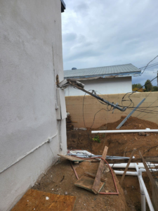 Exposed electrical wiring on a building exterior, showing a project site for Zia Electrical Services in Albuquerque, NM