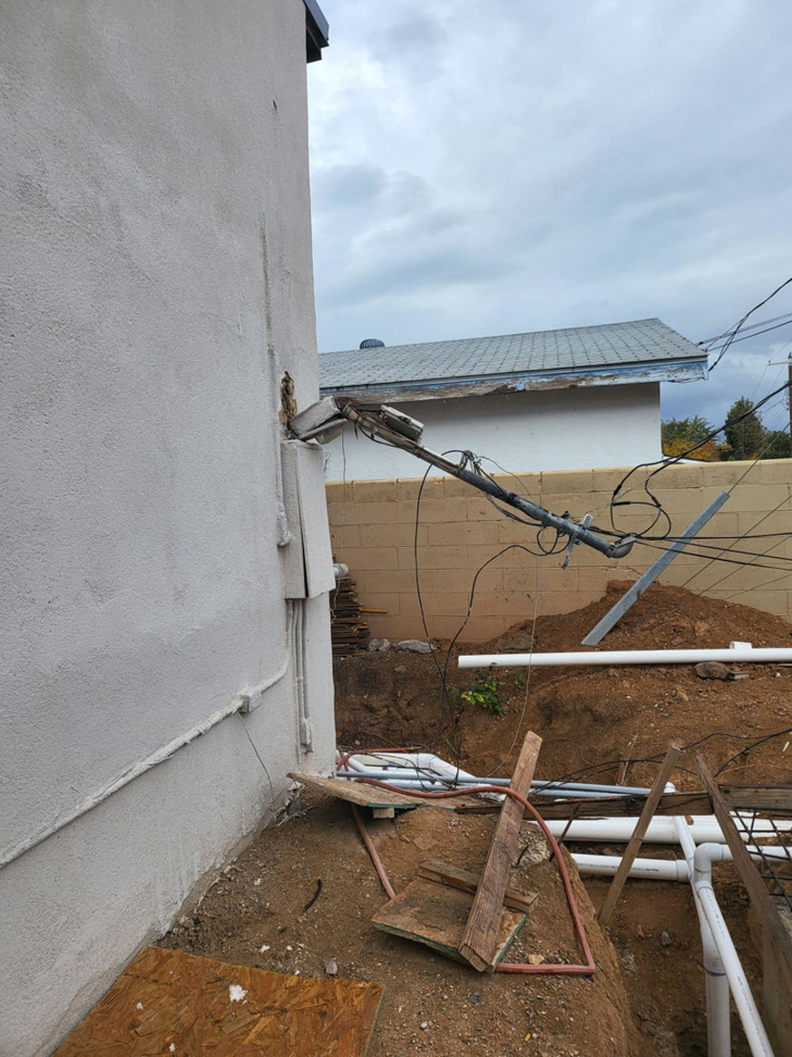 Exposed electrical wiring on a building exterior, showing a project site for Zia Electrical Services in Albuquerque, NM