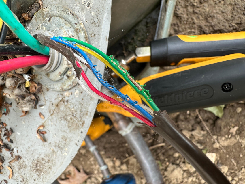 Exposed electrical wiring on an outdoor HVAC unit, showing a repair in progress by Cardinal Repairs in Canton, OH