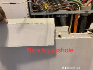 Exposed electrical wiring and a partially removed wall section during a panel repair by The Panel Pal in Bethlehem, GA.