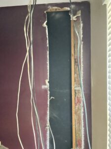 Exposed electrical wiring within a wall cavity, indicating ongoing electrical installation or repair by J. Bathe Electric in Saint Charles, MO.