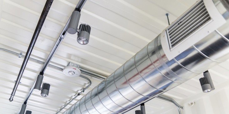 Exposed spiral HVAC ductwork and ventilation in a commercial building, installed by Furnace Doctors Heating & Air Conditioning LLC in Champaign, IL