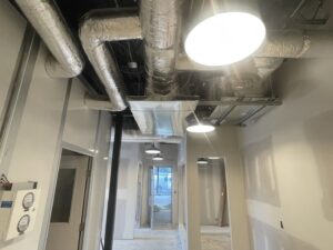 Exposed HVAC ductwork and vents in a commercial building under construction by Elite Home Comfort in Clarksville, TN