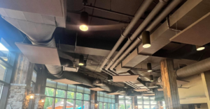 Exposed HVAC ductwork and piping visible on a commercial ceiling, installed by Major HVAC R Inc in Huntingdon Valley, PA