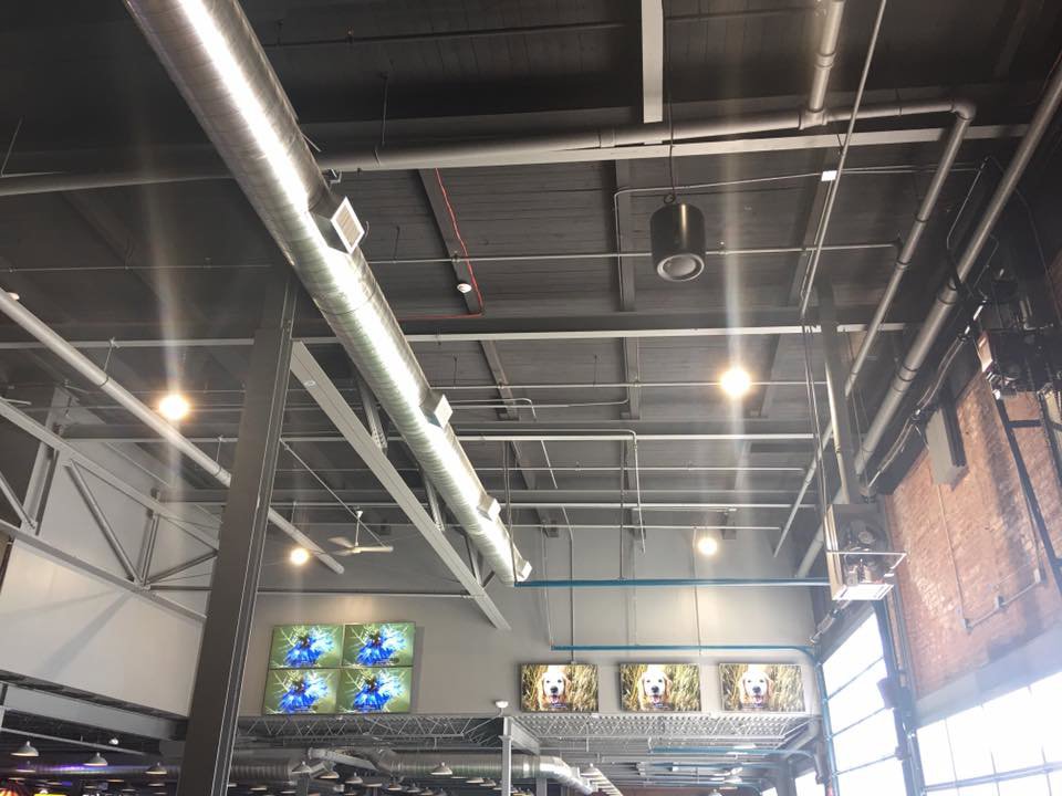 Exposed HVAC ductwork and piping in a commercial space, installed by Enviromax Heating & Cooling in Peekskill, NY.