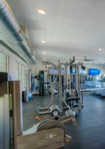 Exposed spiral HVAC ductwork visible in a modern gym, installed by Sun Devil Heating & Cooling INC in Peoria, AZ.